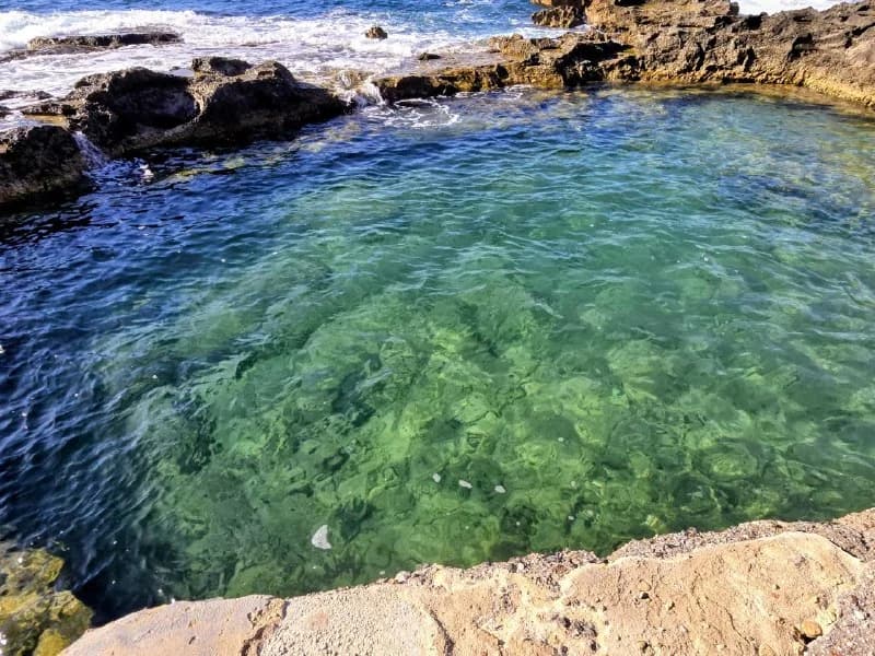 Clear turquoise water in a rocky coastal swimming cove