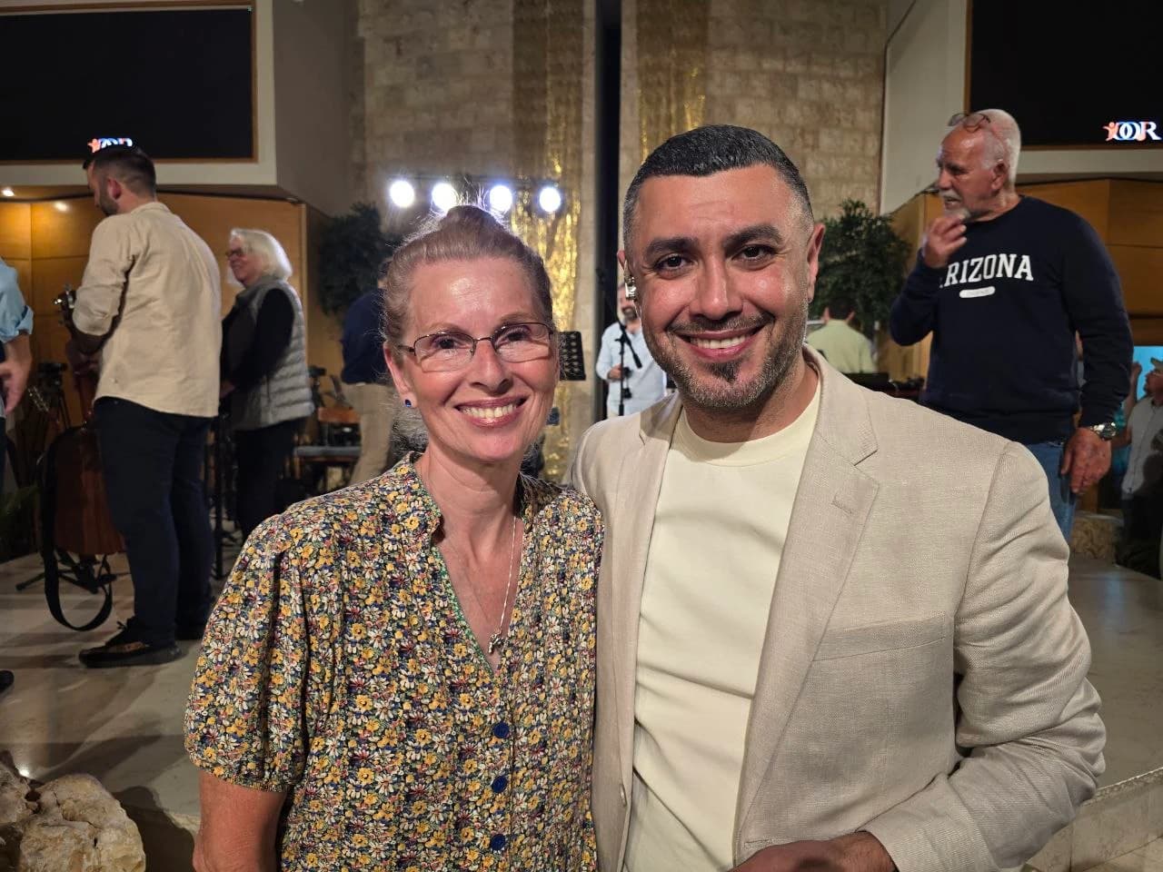 Margaret with a friend at an indoor gathering in Jerusalem
