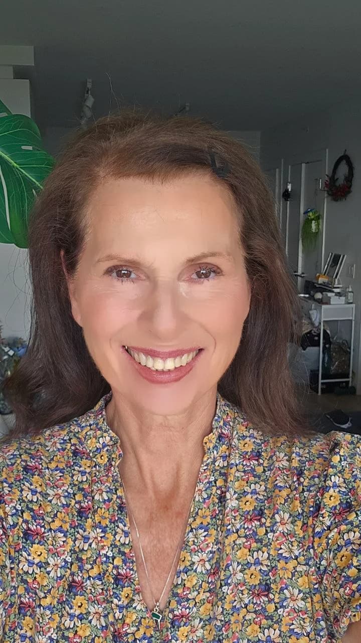 Portrait of Margaret smiling in a floral dress