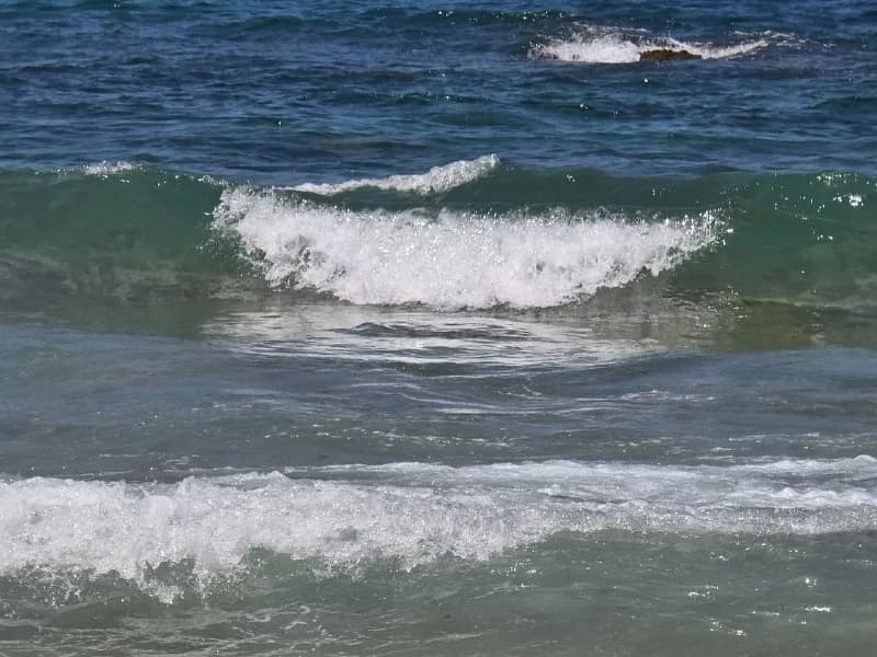 A close view of a green-blue wave beginning to break